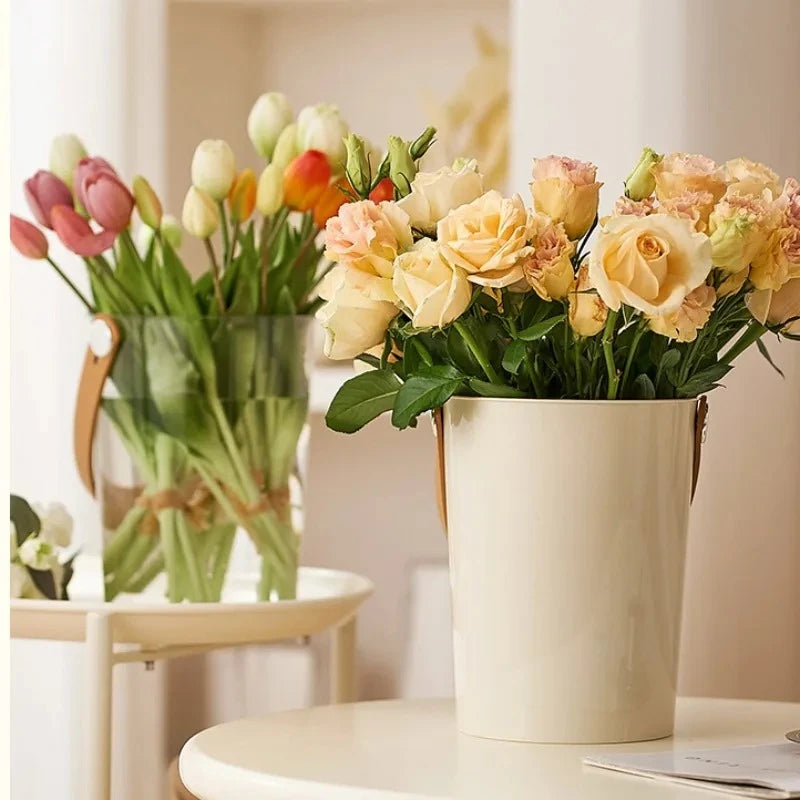 Two Acrylic Cylinder Vases with flowers inside