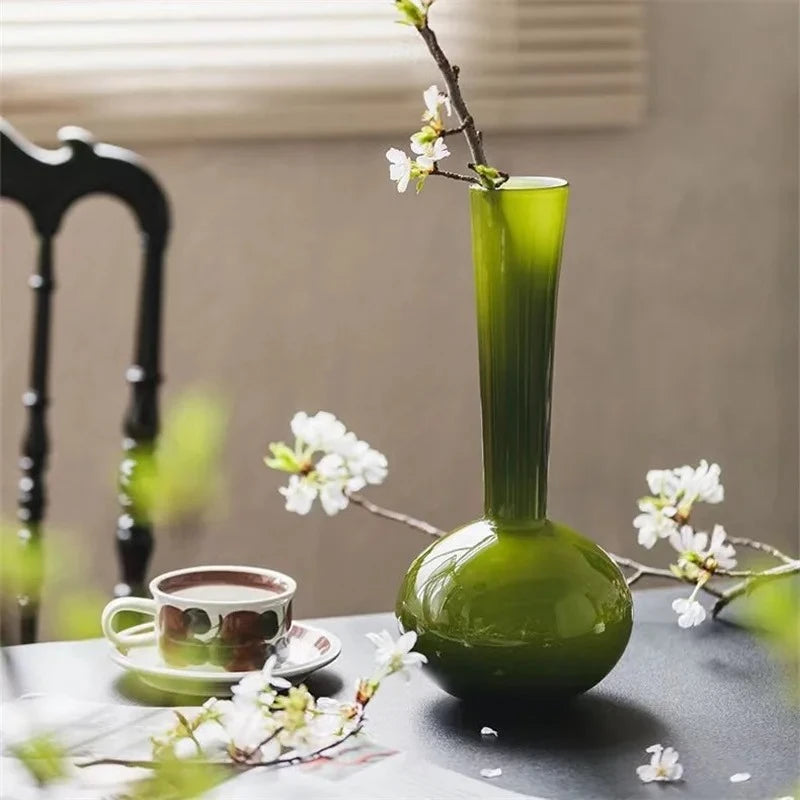 Apple Green Vase on a dark table with a mug next to it 