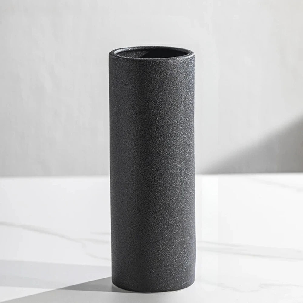 Cylinder Vase in Black on a white marble surface