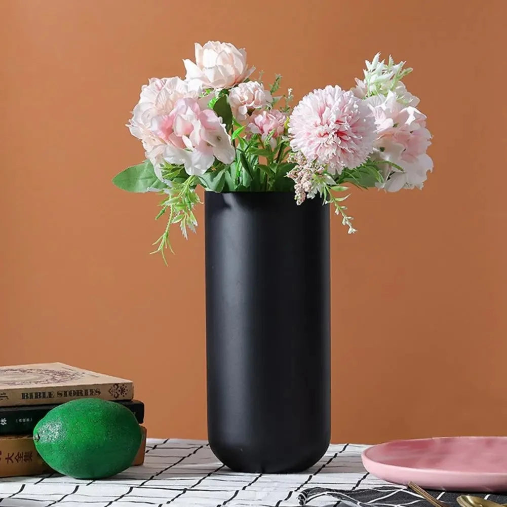 Black Cylinder Vase with a brown background in the back