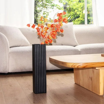 Black Floor Vase next to a coffee table 