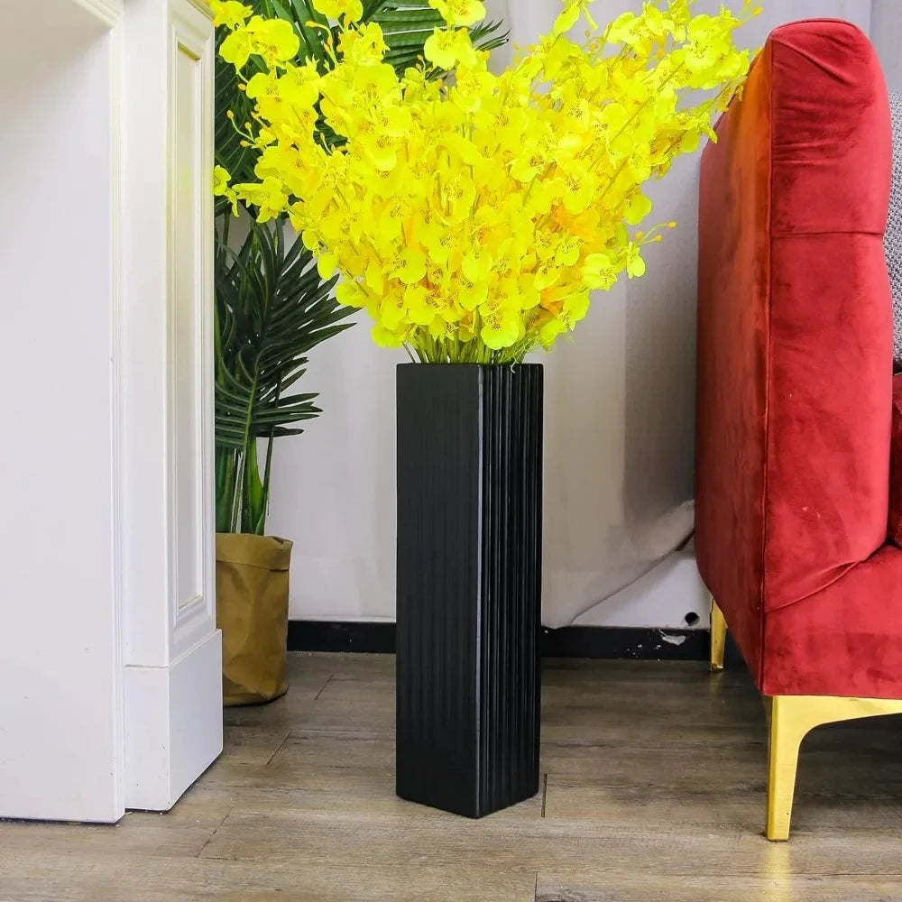 Black Floor Vase next to a sofa 