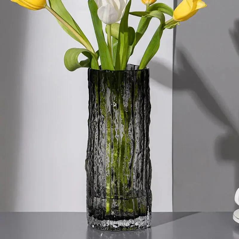 Black Glass Vase with yellow flowers inside on a gray background