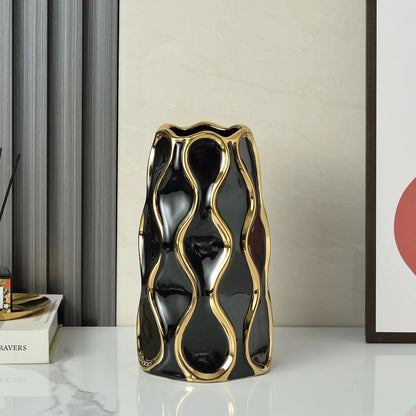 Large Black Modern Vase next to decoratio on a white marble table