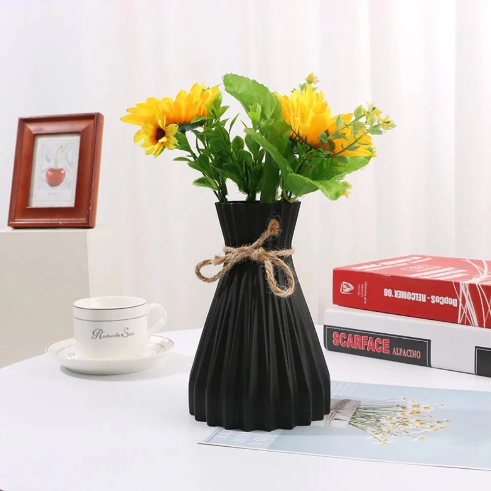 Black Plastic Vase with yellow flowers inside