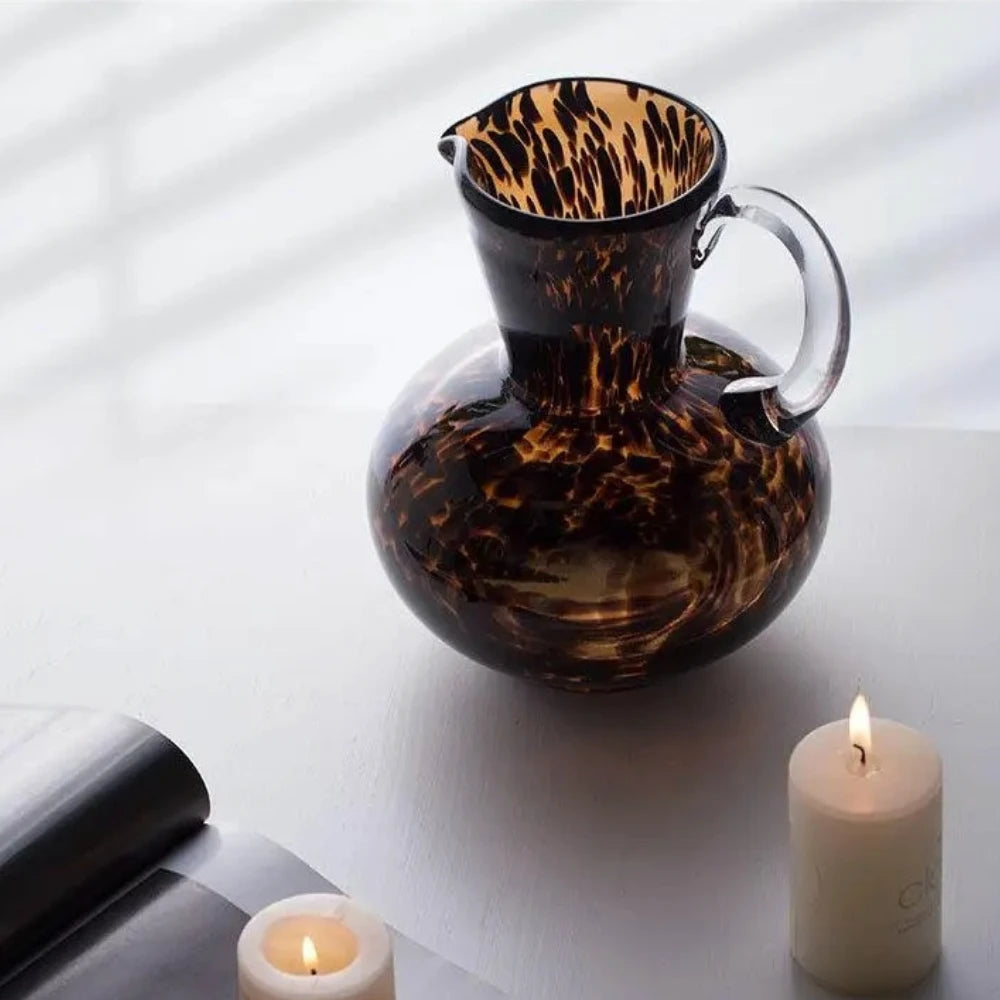 Medium sized Black and Brown Vase next to candles on a white surface