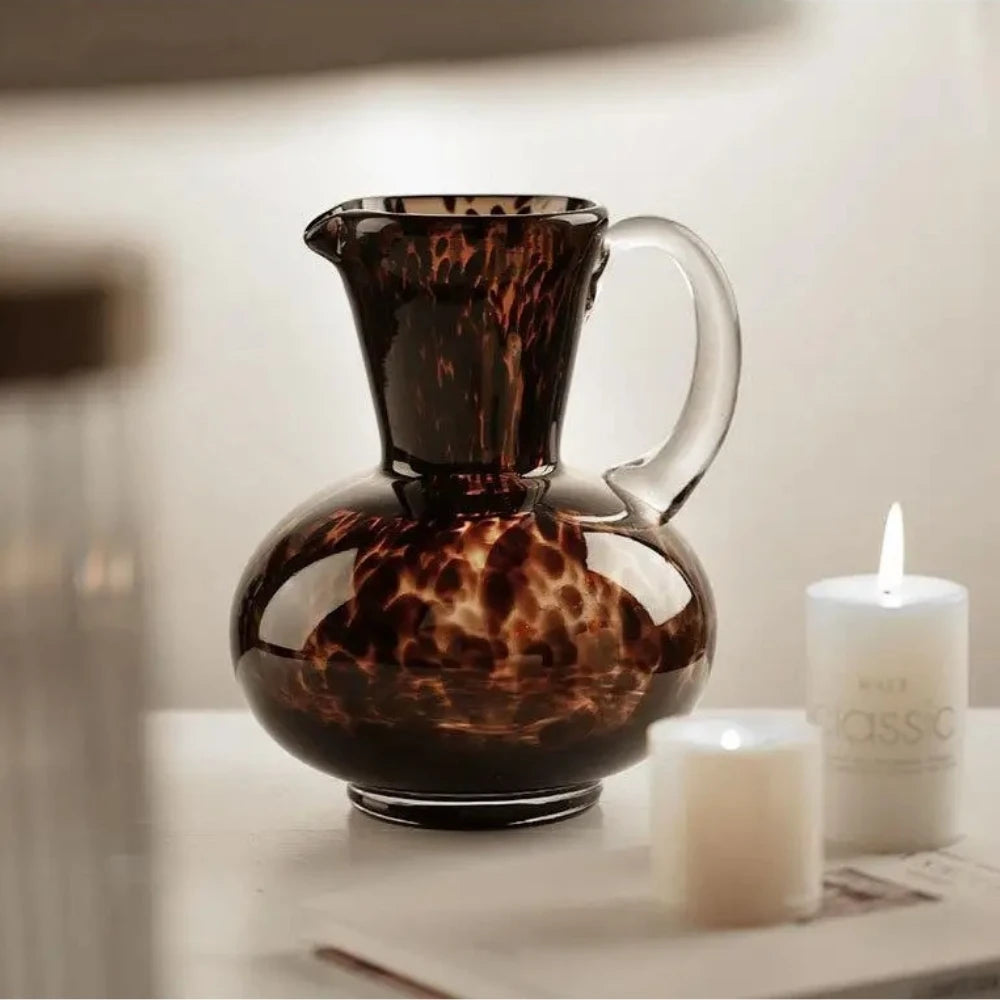 Medium sized Black and Brown Vase next to candles on a white surface