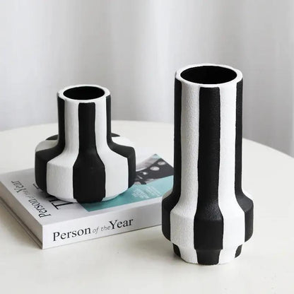 Two Black and White Vases on a white table with a white background