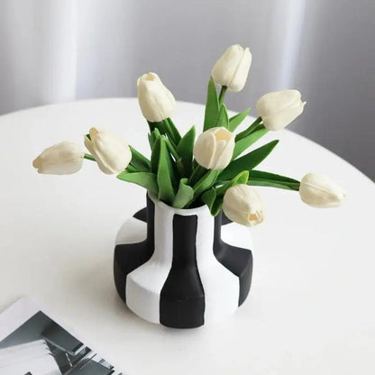 Medium sized Black and white vase with white tulips inside