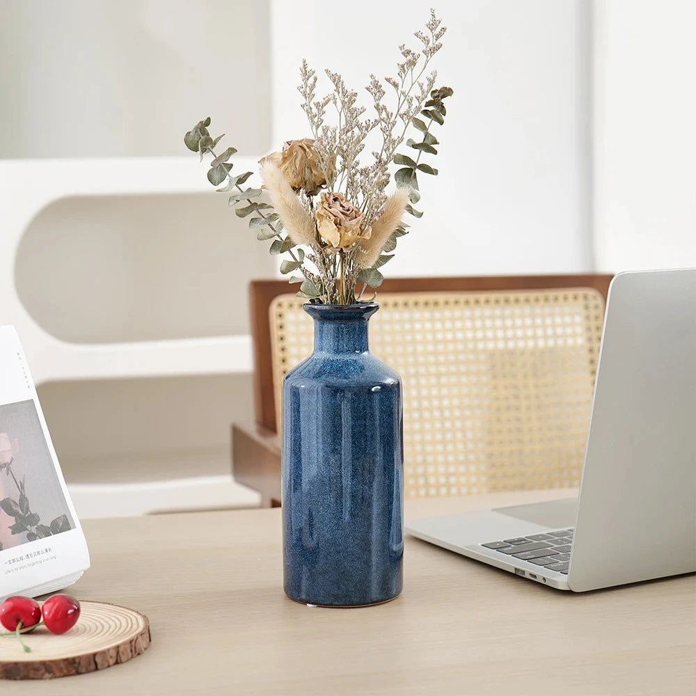 Blue Bud Vase next to a laptop on a beige table