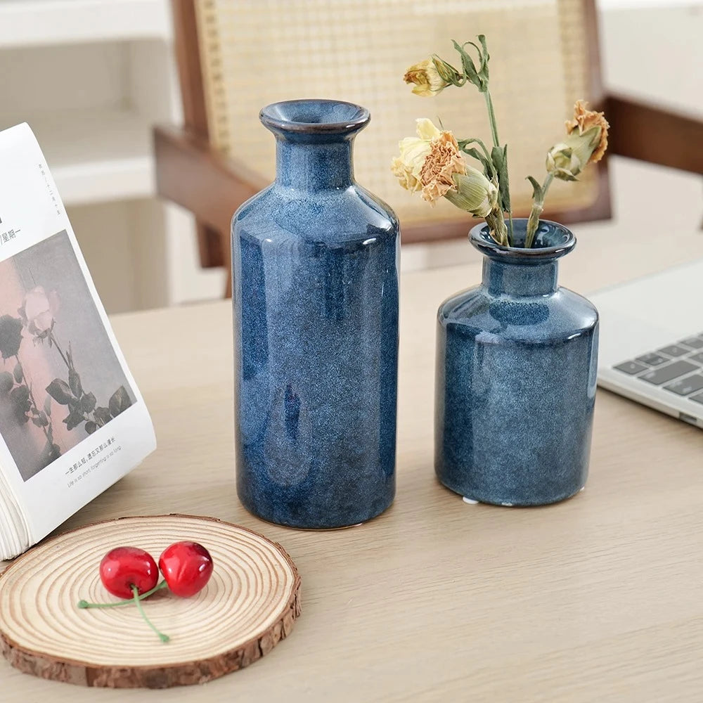 Blue Bud Vases on a wooden table next to decorative elements