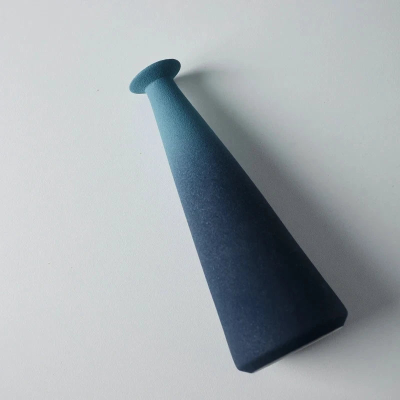 Blue Ceramic Vase laying on a white surface