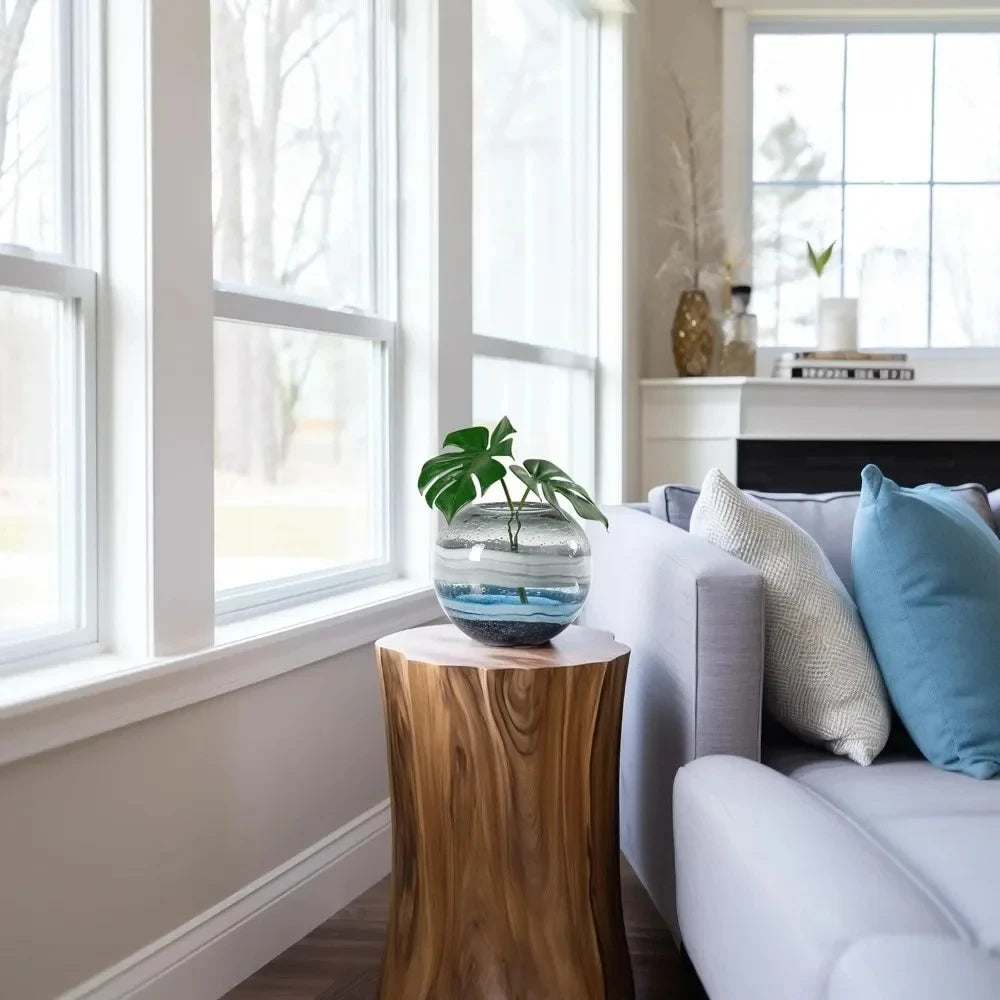 Blue Round Vase standing on a piece of wood next to a sofa 