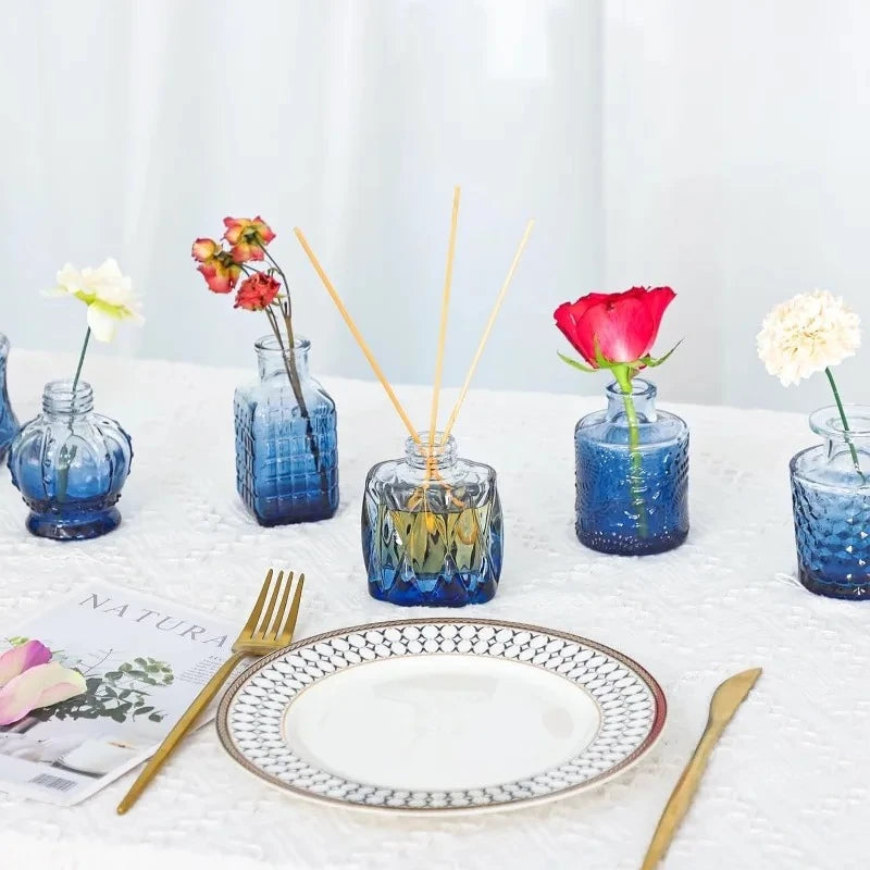 Blue Small Vases on a table next to cutlery