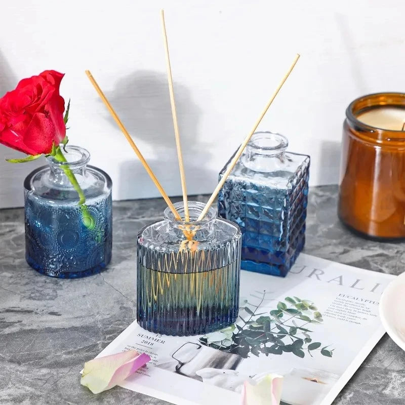 Three Blue Small Vases next to a candle