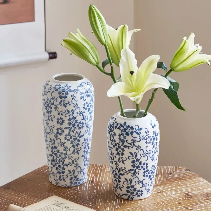 Two Blue White Vases with yellow flowers inside