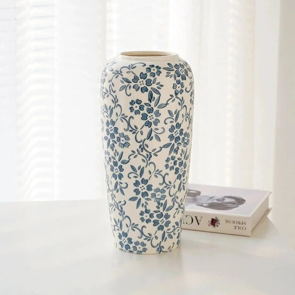 Large Blue White Vase on a white table in front of a book