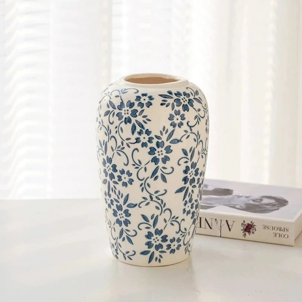 Blue White Vase on a white table in front of a book