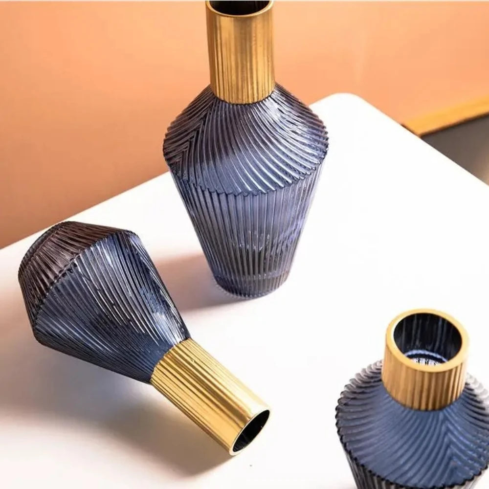 Three Blue and Gold Vases on a white surface 