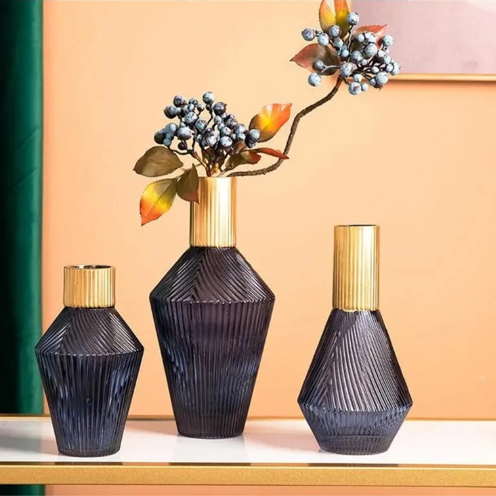 Three Blue and Gold Vases on a white surface