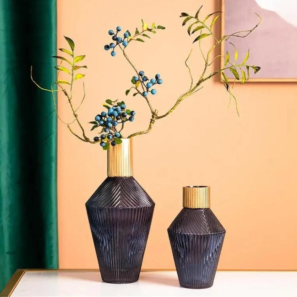 Two Blue and Gold Vases on a white surface with flowers inside