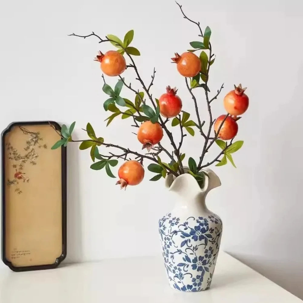 Large Blue and White Vase with plants inside on a white table