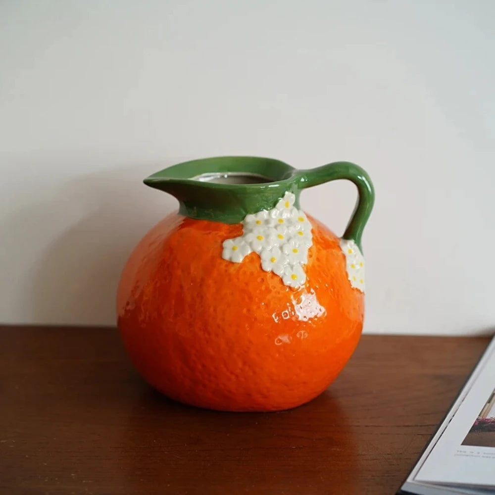 Bright Orange Vase on a brown wooden desk