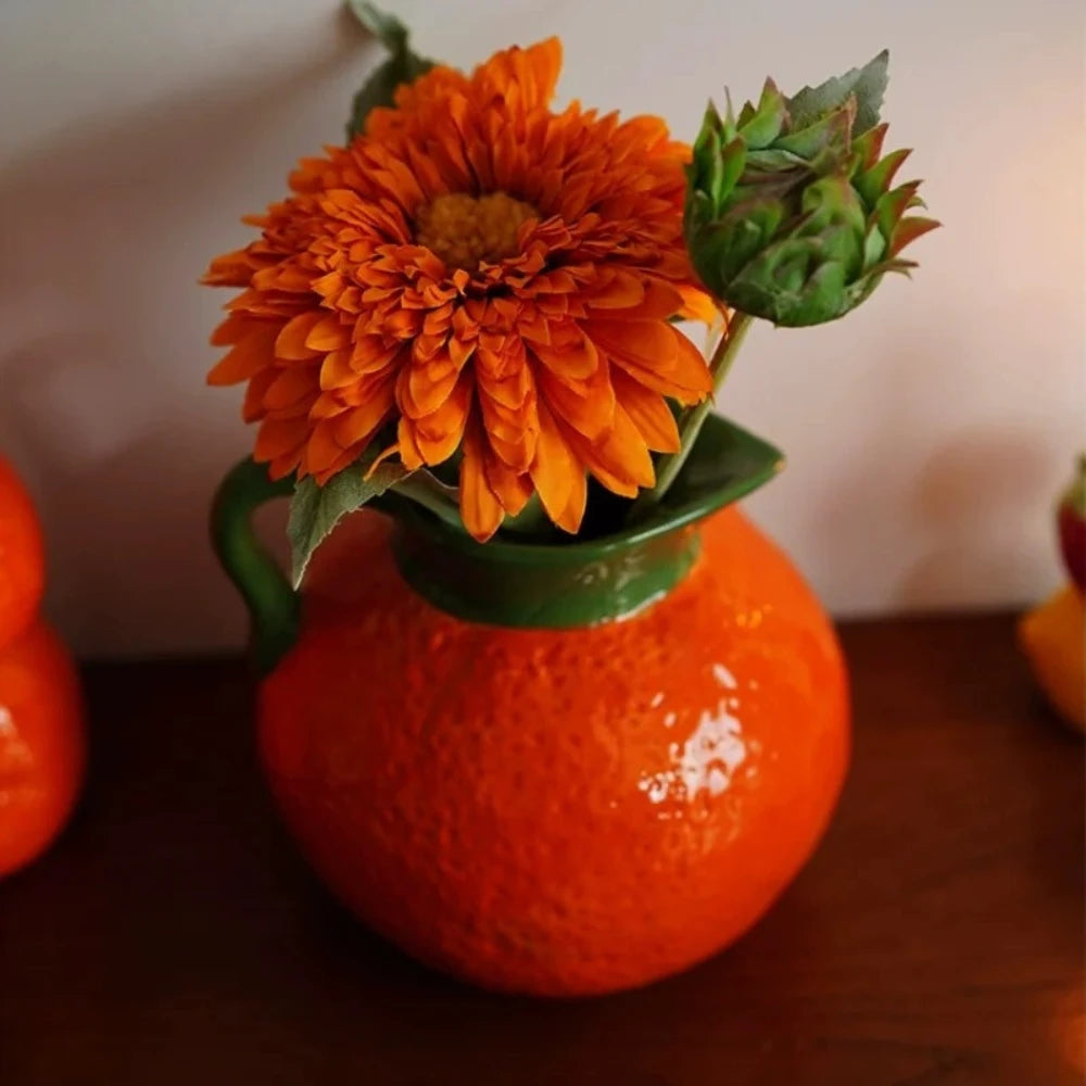 Bright Orange Vase with orange flowers inside