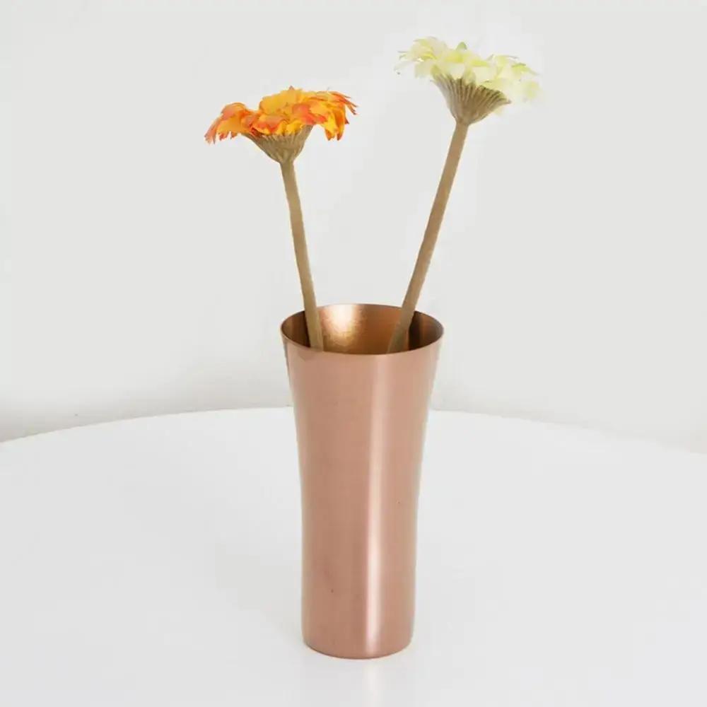 Brown Metal Vase With Flowers Inside