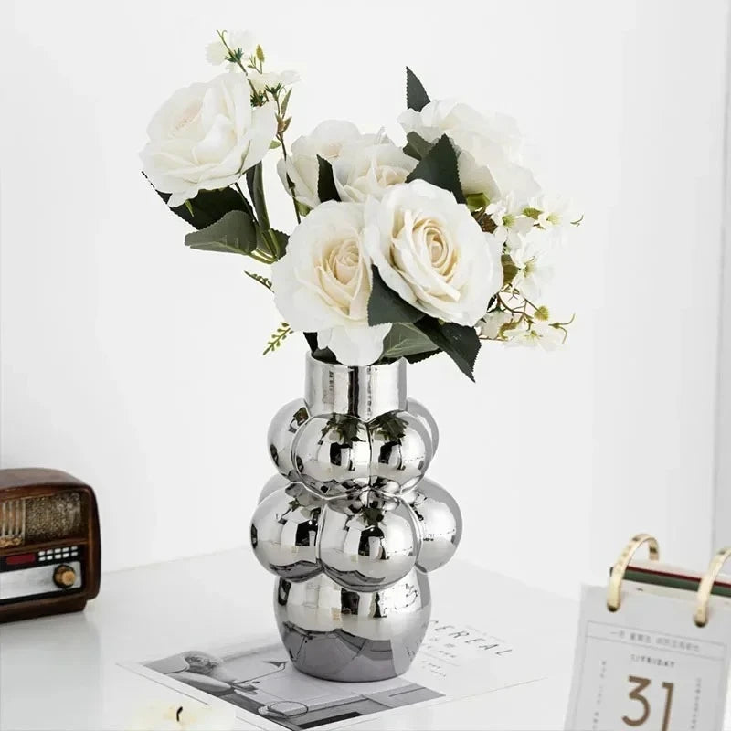 Bubble Vase with white flowers inside on a white table