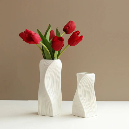 Two Ceramic Bud Vases in large and medium on a brown background with red tulips inside