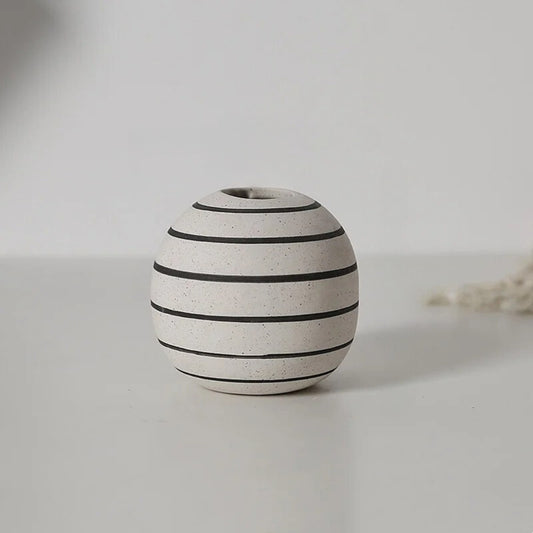 Small Ceramic Round Vase on a gray table