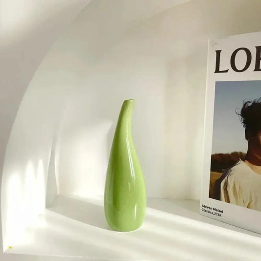 Ceramic Small Vase in olive green next to a book