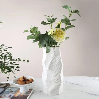 Ceramic Stone Vase with green plants inside on a white marble table