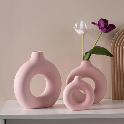 Three Ceramic Vases in Pink on a white shelf