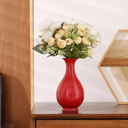 Chinese Red Vase With Flowers Inside on a Nightstand