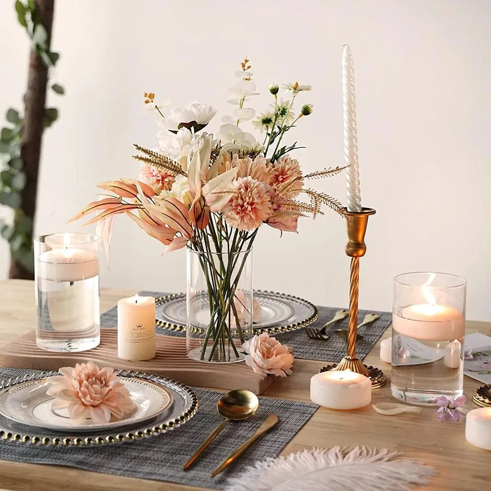 Crystal Cylinder Vase with flowers inside next to decoration on a table