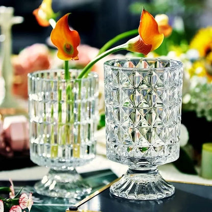 Two Crystal Pedestal Vases with orange flowers inside