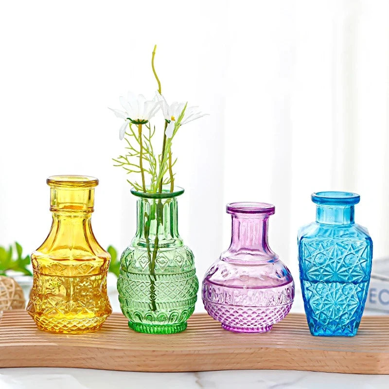 Four Crystal Small Vases in different colors on a wooden tray