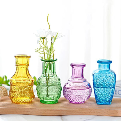 Four Crystal Small Vases in different colors on a wooden tray