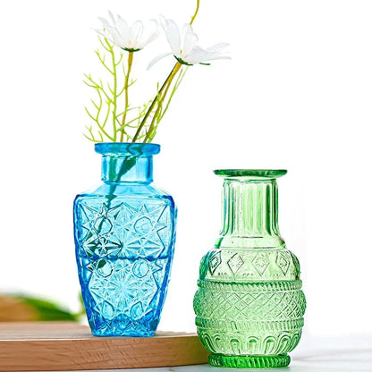 Two Crystal Small Vases in blue and green on a wooden board