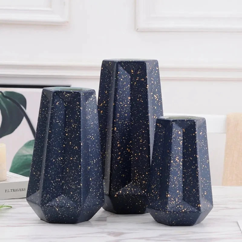 Three Dark Blue Vases on a white marble table