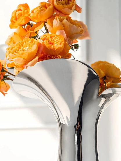 Close up from a Flower Metal Vase with orange flowers inside