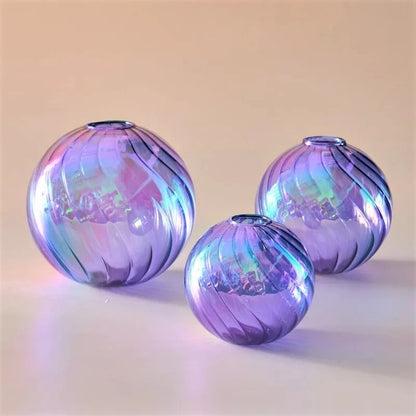 Purple Glass Round Vases on a peach surfaces