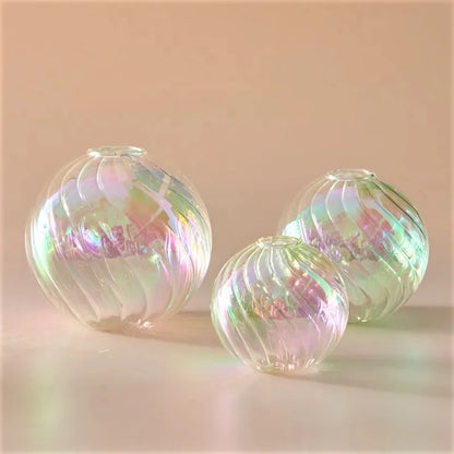 Clear Glass Round Vases on a peach surface