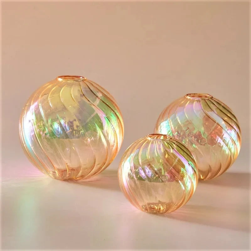 Orange Glass Round Vases on a peach surface