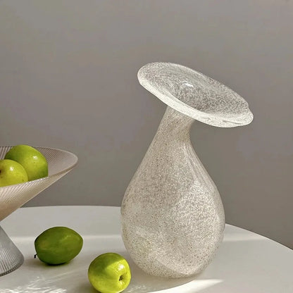 Glass White Vase standing next to a couple of apples 