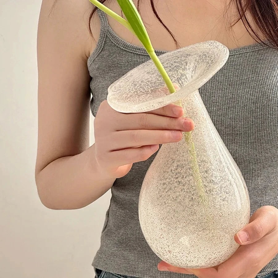 Person holding a Glass White Vase with a flower inside