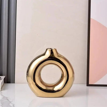 Gold Bud Vase on a shiny white surface