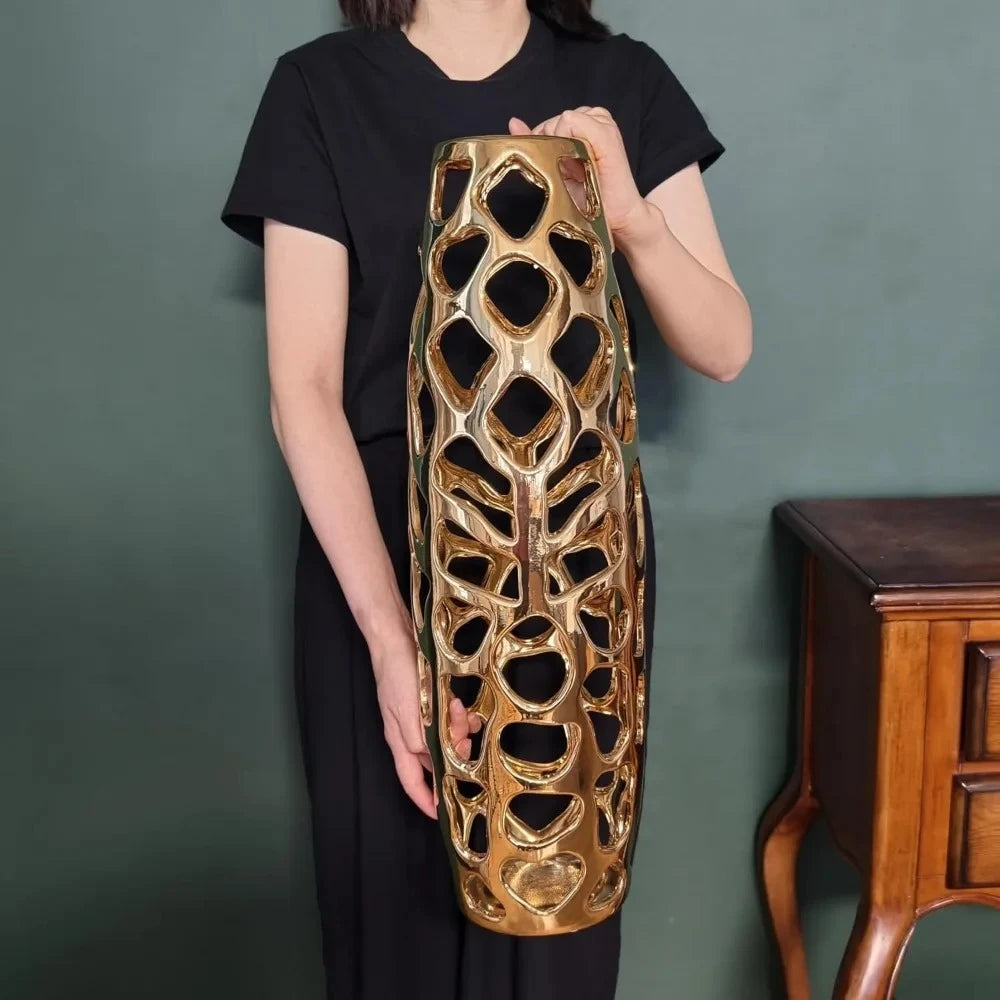 Person holding a Gold Floor Vase for size reference